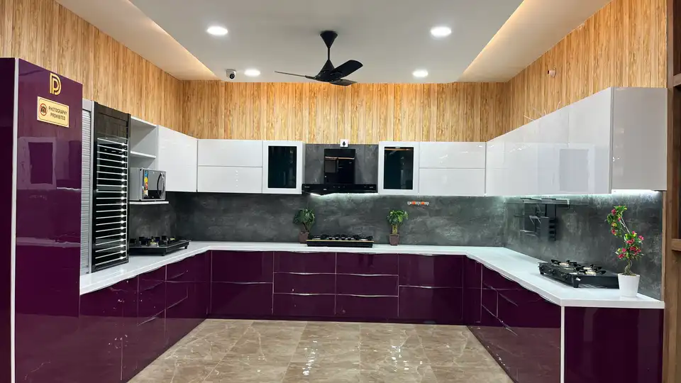 Modular kitchen showroom display with gloss shutters, hob and overhead storage