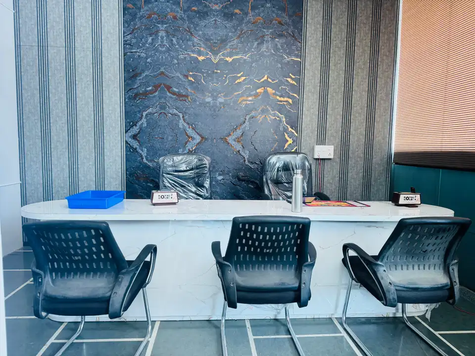 Reception desk with marble-finish feature wall and vertical-slat panelling